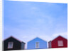 Beach huts in a row against sky by Assaf Frank